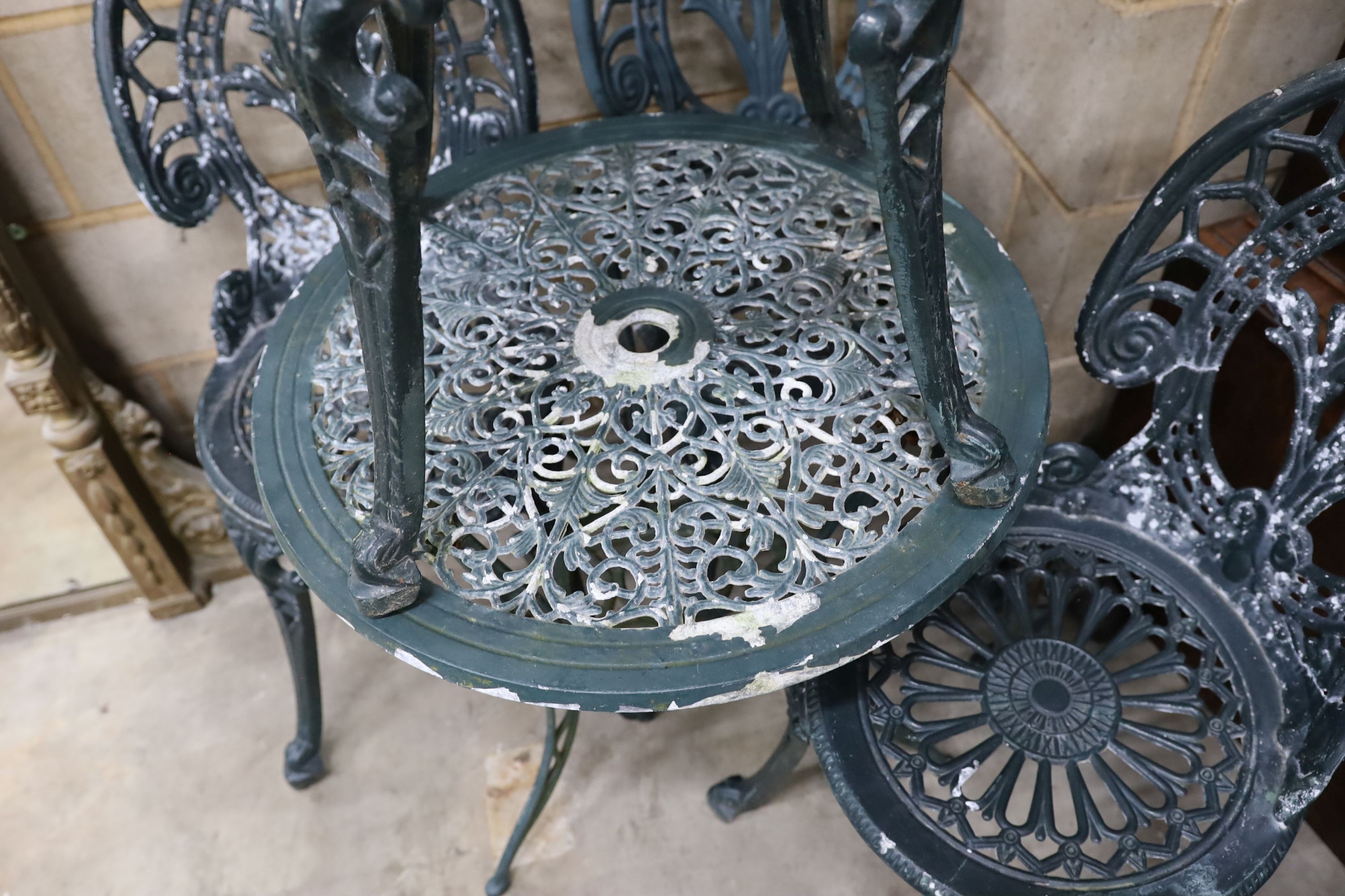 A Victorian style aluminium circular garden table, diameter 60cm, height 62cm and four chairs